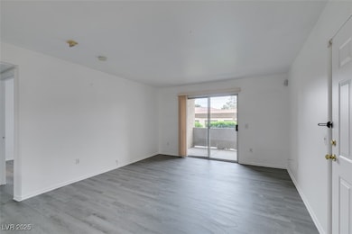 Unfurnished room with wood finished floors and bas