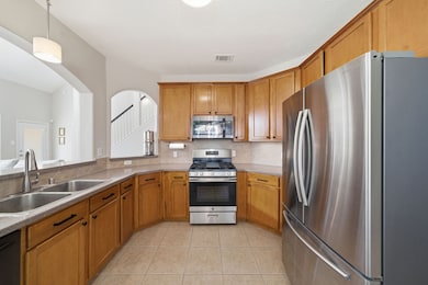 The kitchen has new stainless steel appliances, ample cabinet space for storage, and archway that offer a
 view into the living room.
 This home features an open
 floor plan, with the living
 room flowing seamlessly into