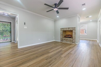 Family room with ceiling fan, ornamental molding, 