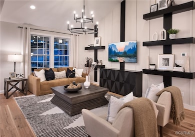 Living room with lofted ceiling and light hardwood