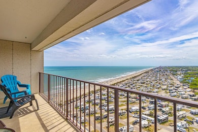 Balcony featuring a view of the beach and a water 