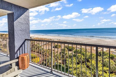 Balcony with a view of the beach and a water view