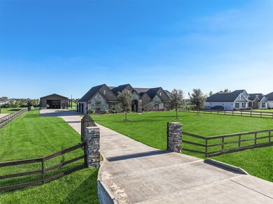 A lengthy concrete drive with an automatic gate an