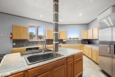 Kitchen with a sink, built in refrigerator, backs