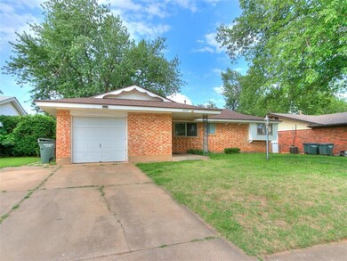 Ranch-style home featuring a front lawn, a garage,