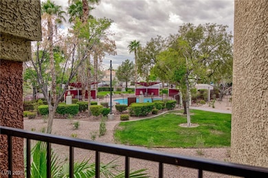 View of property's community featuring a swimming pool and a balcony