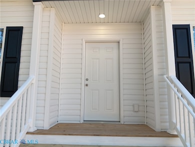 Entrance to property featuring a wooden deck
