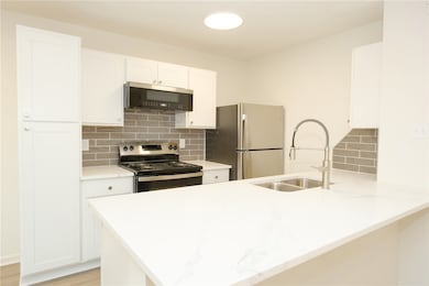Kitchen featuring stainless steel appliances, a si