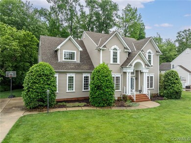 Traditional-style home with roof with shingles and