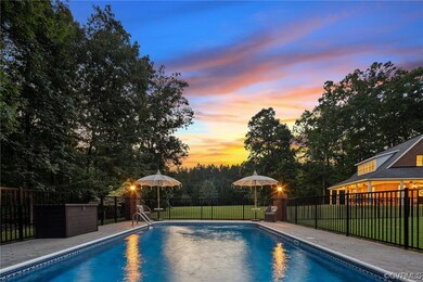 Pool at dusk featuring a lawn