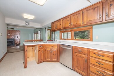 Kitchen with knotty pine finish cabinets, linen fi