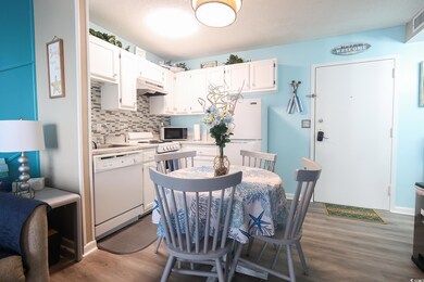 Dining room featuring sink and dark wood-type floo