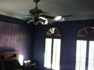 THE MASTER BEDROOM WITH WOOD SHUTTERS AND CUSTOM P
