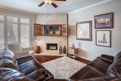 Flat screen TV hidden in unique artwork in living 