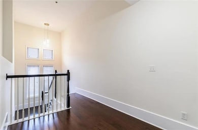 Corridor with dark hardwood / wood-style flooring