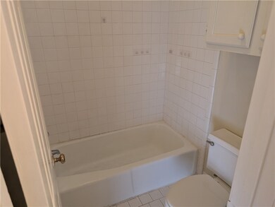 Bathroom with tile patterned floors and toilet