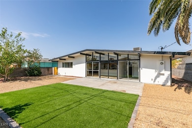 Rear view of house featuring a fenced backyard and