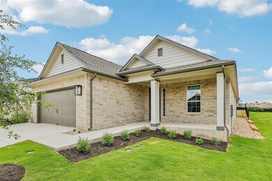 Ranch-style home with brick siding, covered porch