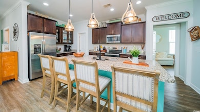 Kitchen featuring visible vents, crown molding, da