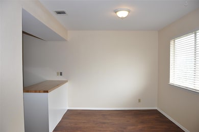 Empty room with wood finished floors and baseboar
