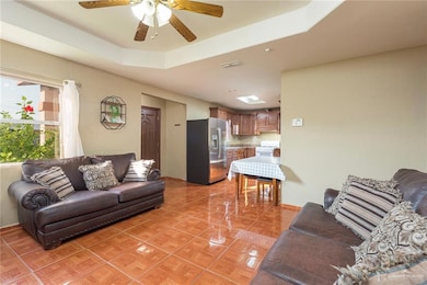 The open layout allows seamless interaction between the living room and the kitchen, creating a welcoming space that brings everyone together. Perfect for entertaining or casual family dinners, the setup enhances every occasion. Envision your family enjoying meals and laughter in this beautifully connected space.