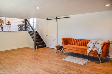 Lower level family room with a sliding barn door t