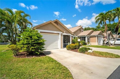 Single story home with a garage, stucco siding, a front lawn, and driveway