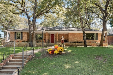 Ranch-style house featuring a front yard and brick siding