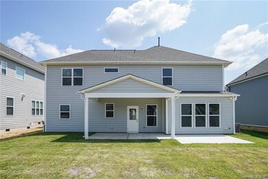 Back of home with covered patio