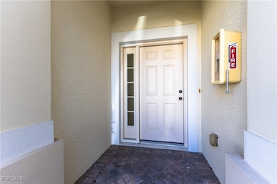 Entrance to property featuring stucco siding