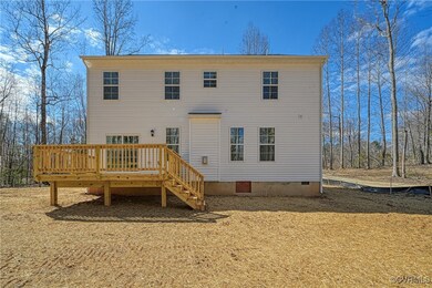 Back of property with crawl space and a deck
