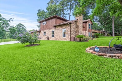 This home features a large front yard with beautif