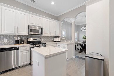 Another view of the kitchen and a peak into the dining room. Door off the dining room leads to the second floor balcony.