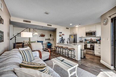 Living room featuring a textured ceiling, sink, an