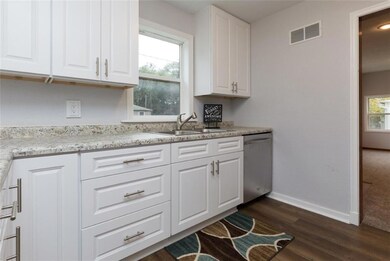 Bright kitchen, dw right by sink.