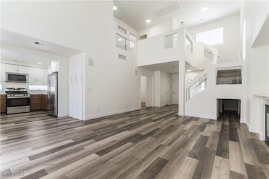Unfurnished living room featuring a high ceiling,