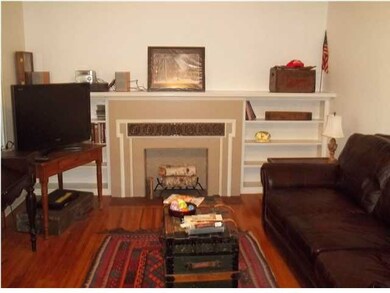 Living room with decorative fireplace and bookcase