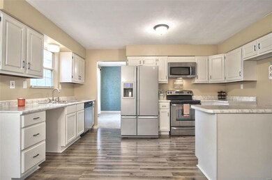 Lovely kitchen with stainless steel appliances throughout and updated flooring.