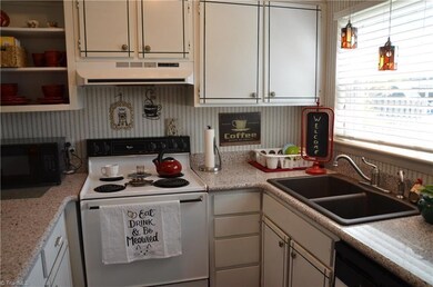 Light and cherry kitchen has a larger window than most of these homes. Upgraded countertops and gorgeous sink!
