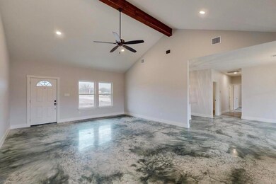 Unfurnished living room featuring concrete floors,