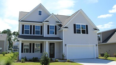 View of front of house with a garage and a front l