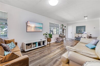 Living area featuring visible vents, ornamental mo