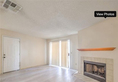 Unfurnished living room featuring wood finished fl