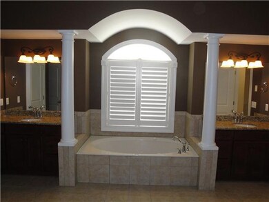 Double vanity in master bathroom with jetted tub and his and her closets with built in shelving!