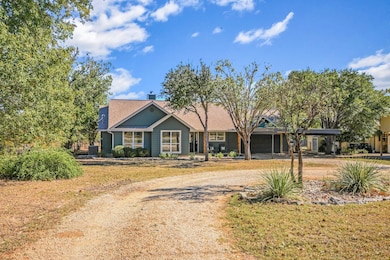 Ranch-style house featuring dirt driveway, a chimney, and a front lawn