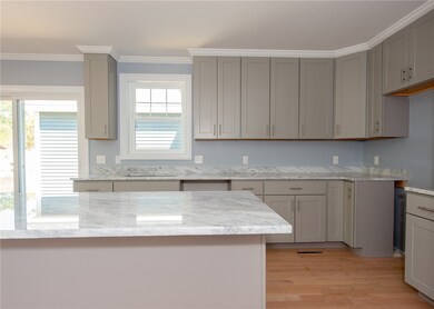 Kitchen -- ample cabinetry, center island, granite