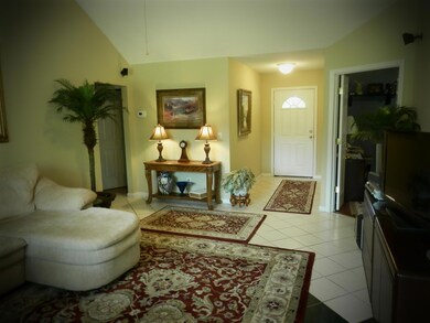 Vaulted ceilings and custom tile flooring throughout living area.