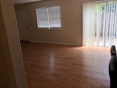 Spare room featuring wood finished floors and baseboards
