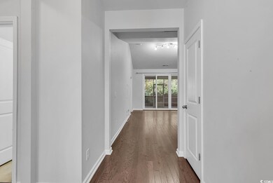 Hall with dark hardwood / wood-style floors
