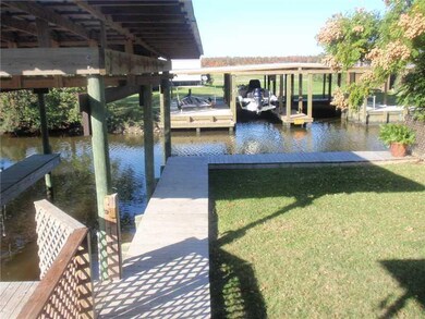 Exterior Back. Wood walkway all around boat slips 